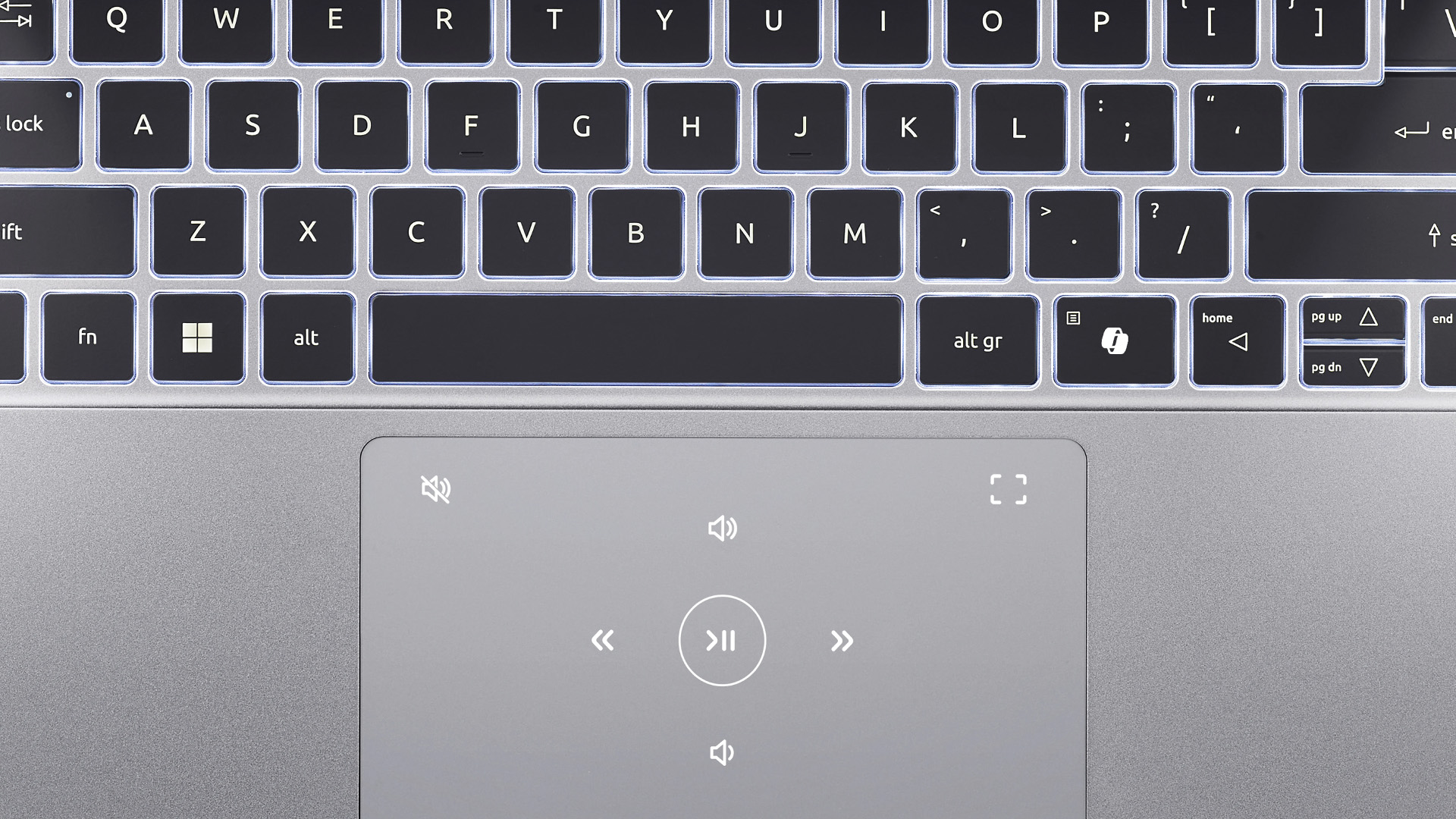 Close-up of an Acer laptop keyboard and touchpad with illuminated media controls.