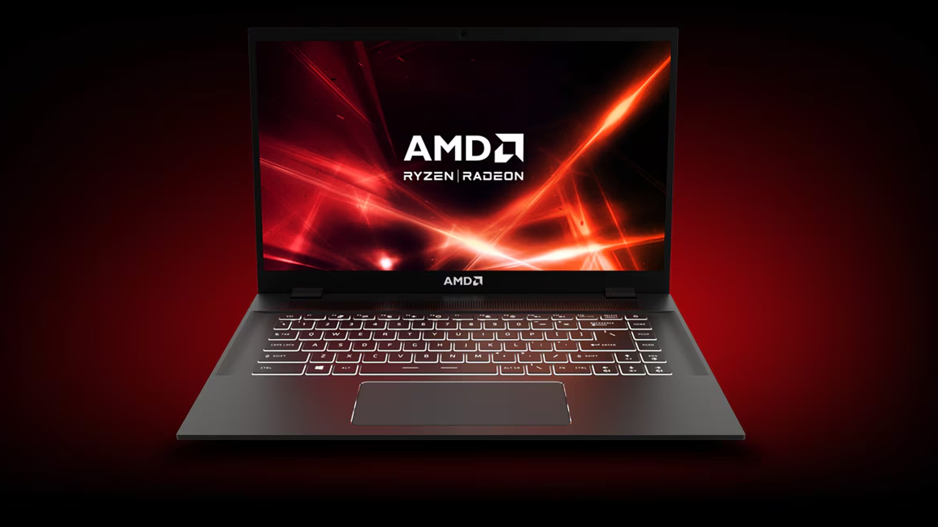 An AMD Ryzen laptop displaying a red brand background graphic on screen.