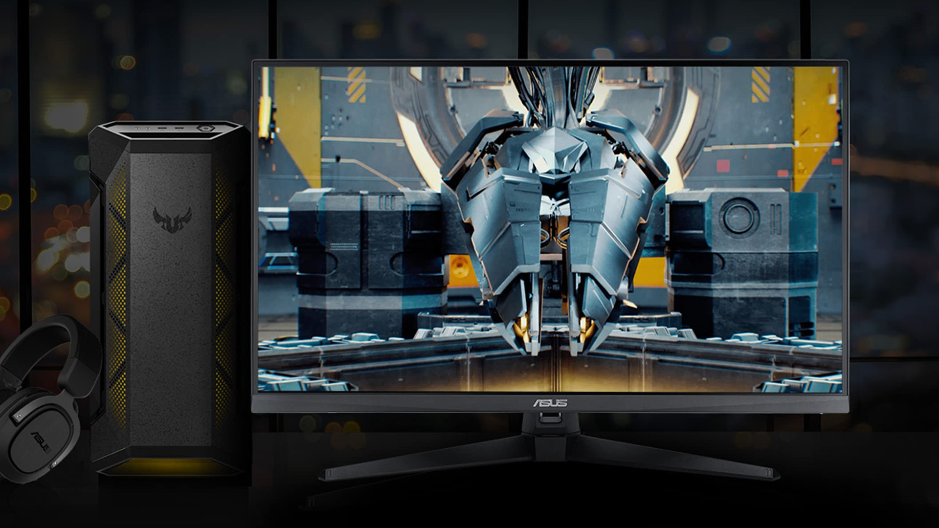 ASUS TUF gaming desktop PC and monitor displaying a robotic character with a headset.