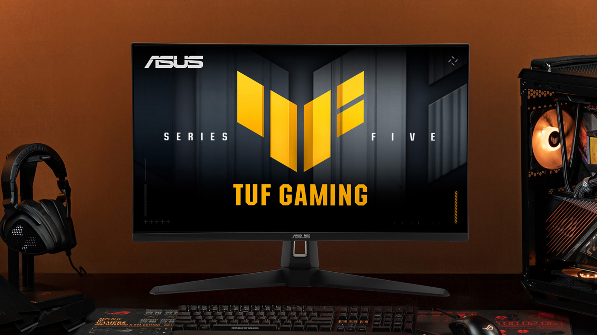ASUS TUF Gaming VG27AQM5F monitor displayed on a desk in a PC setup.