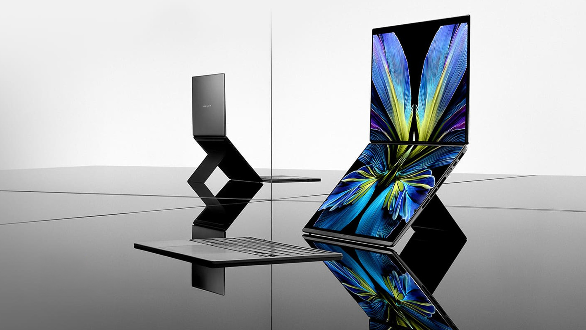 ASUS Zenbook Duo dual screen laptop propped open on a highly reflective desk.