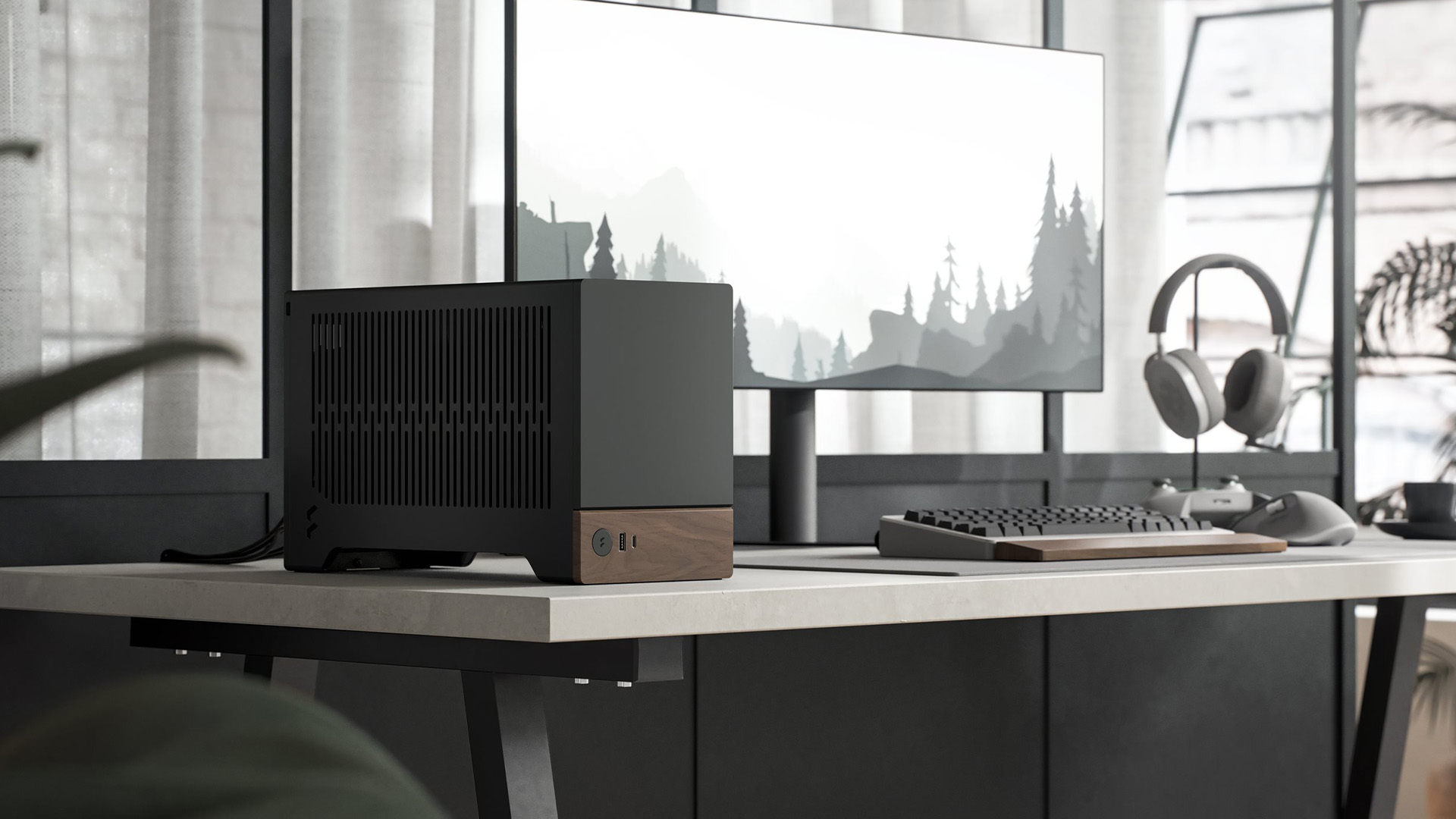 A compact wood-accented PC case resting on a clean office desk next to a monitor.