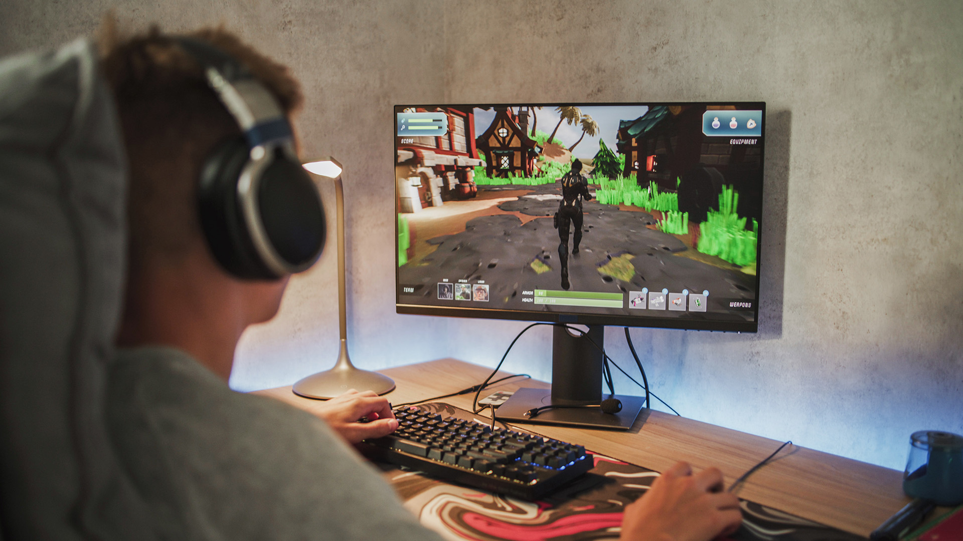Competitive gamer playing on a high-refresh 27-inch gaming monitor.