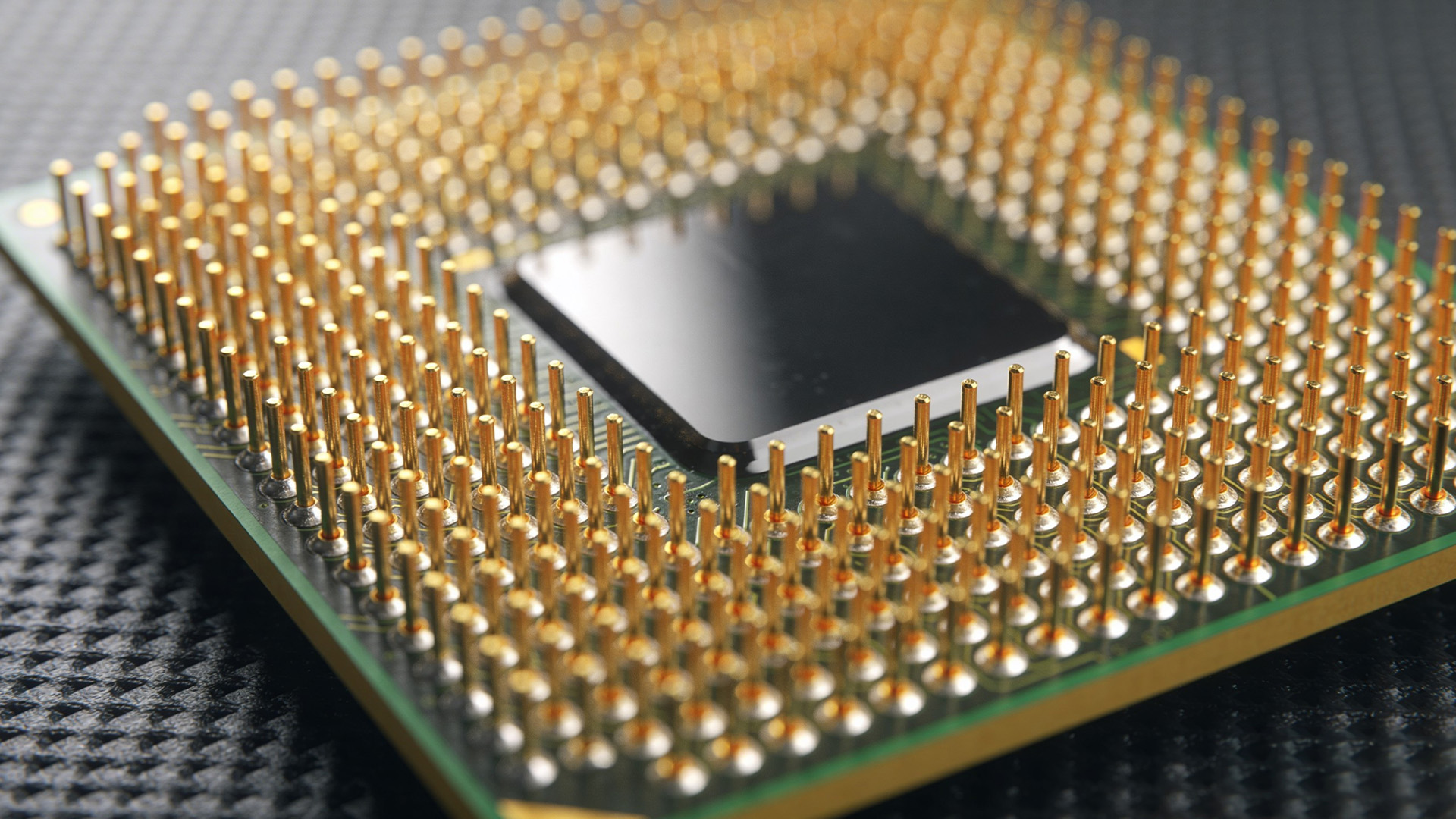 A close-up view of a processor showing gold contact pins underneath.
