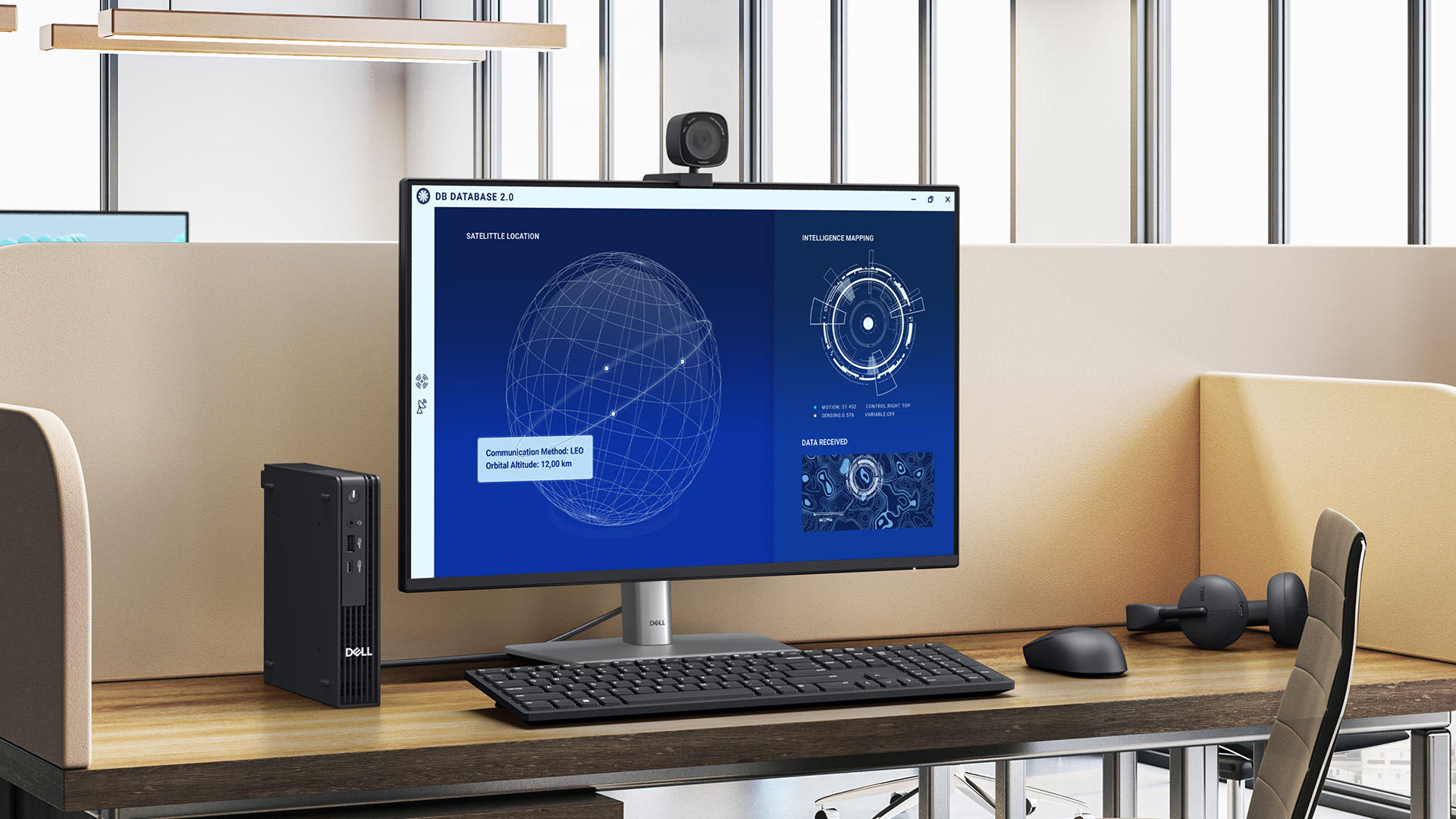A compact Dell Micro desktop PC and monitor displaying data in an office cubicle.