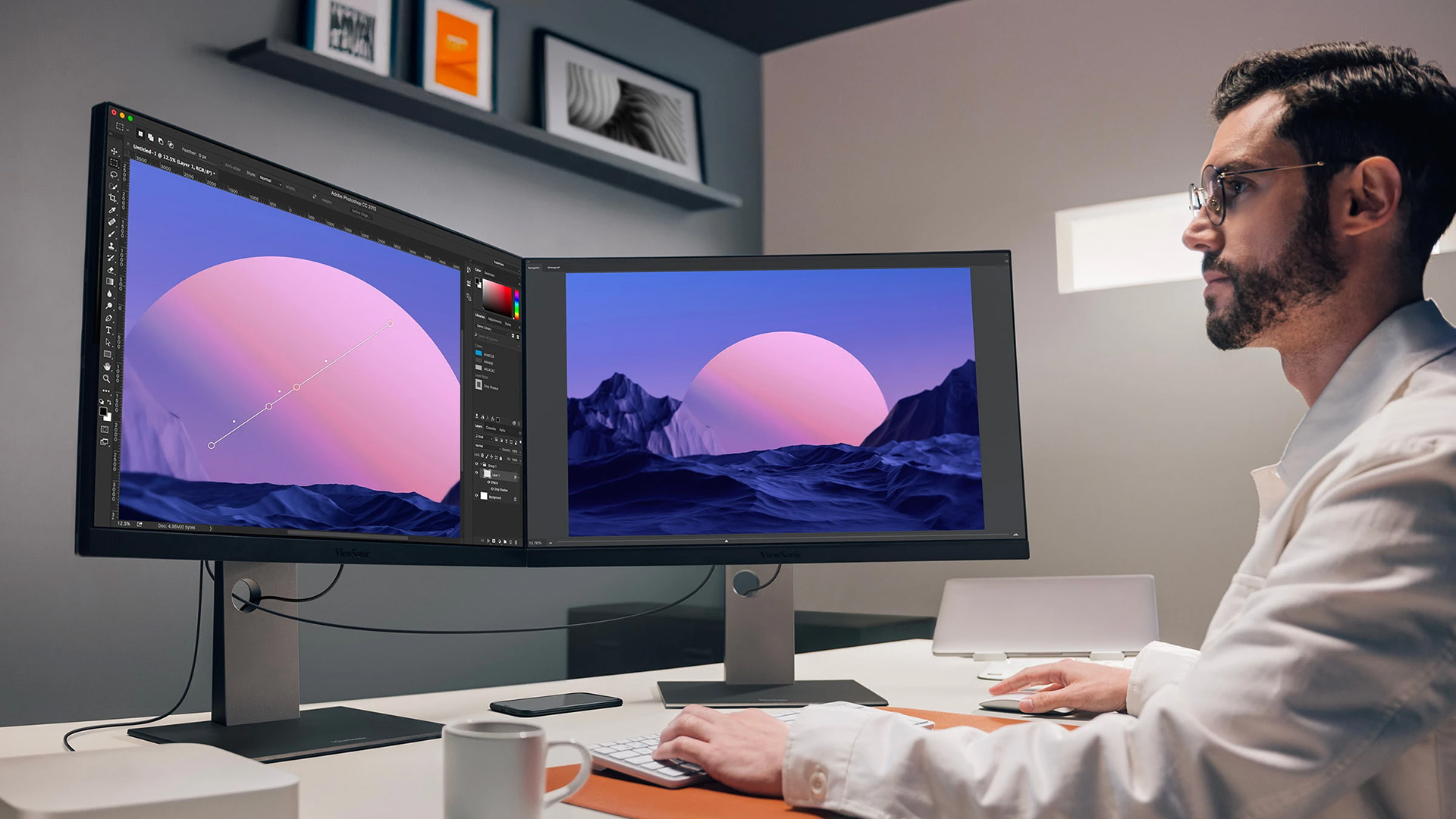 A professional designer editing photos on dual ViewSonic monitors in a bright workspace.