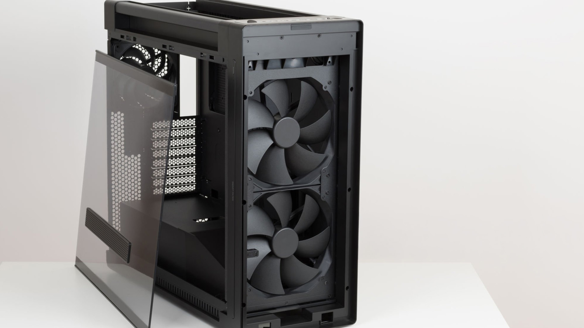 A black dual-chamber PC case with a transparent side panel and front fans.
