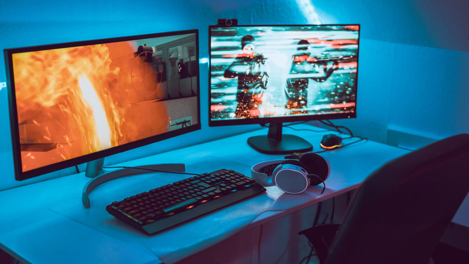 A dual-monitor gaming setup with vibrant lighting for an immersive experience.