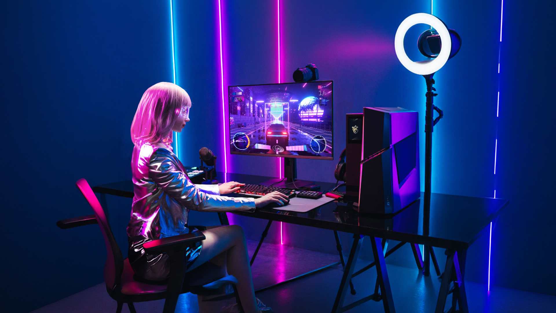 Gamer playing a racing game at a neon RGB desktop setup.