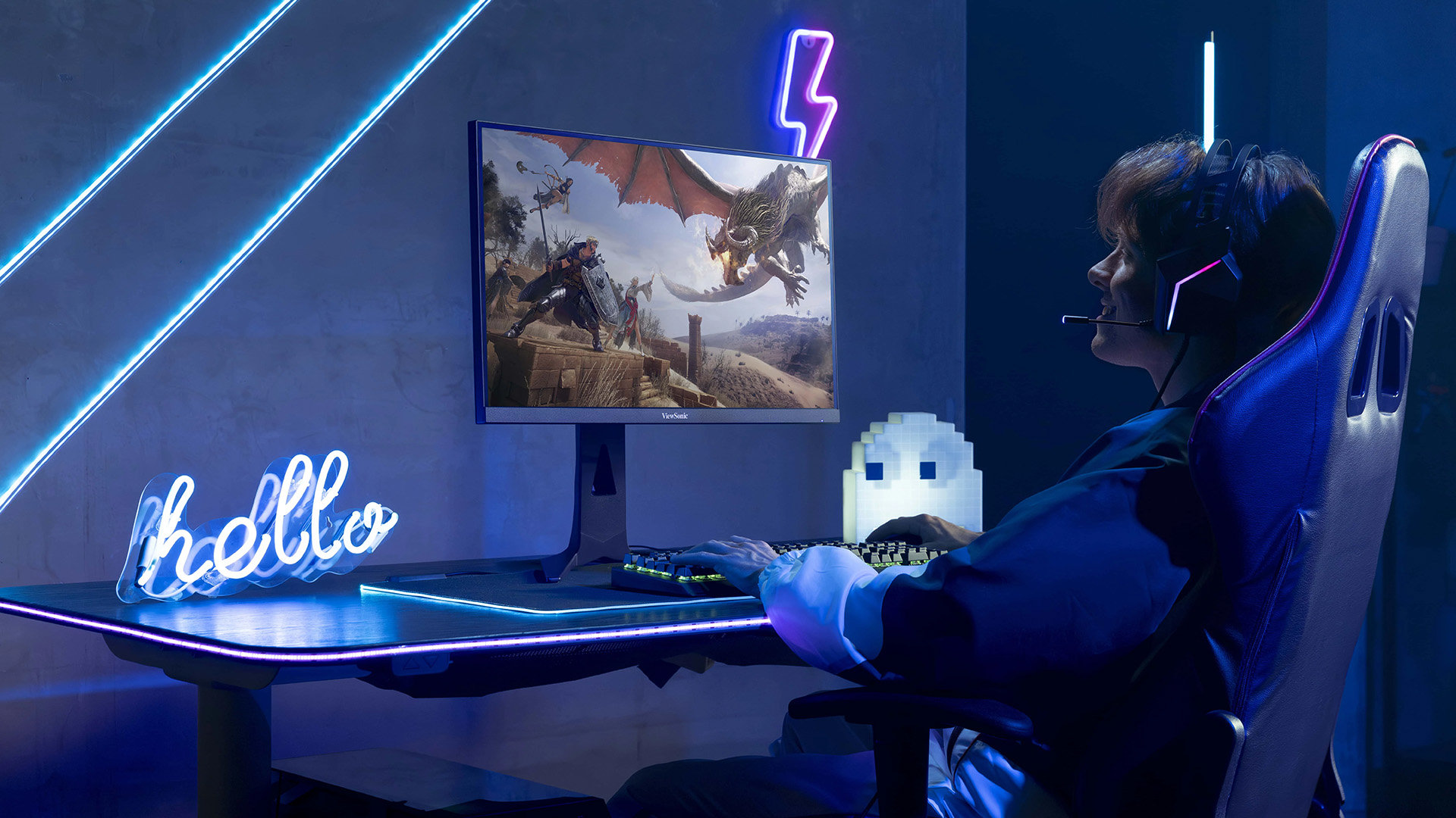 A gamer playing an RPG game on a ViewSonic monitor in a neon lit room.