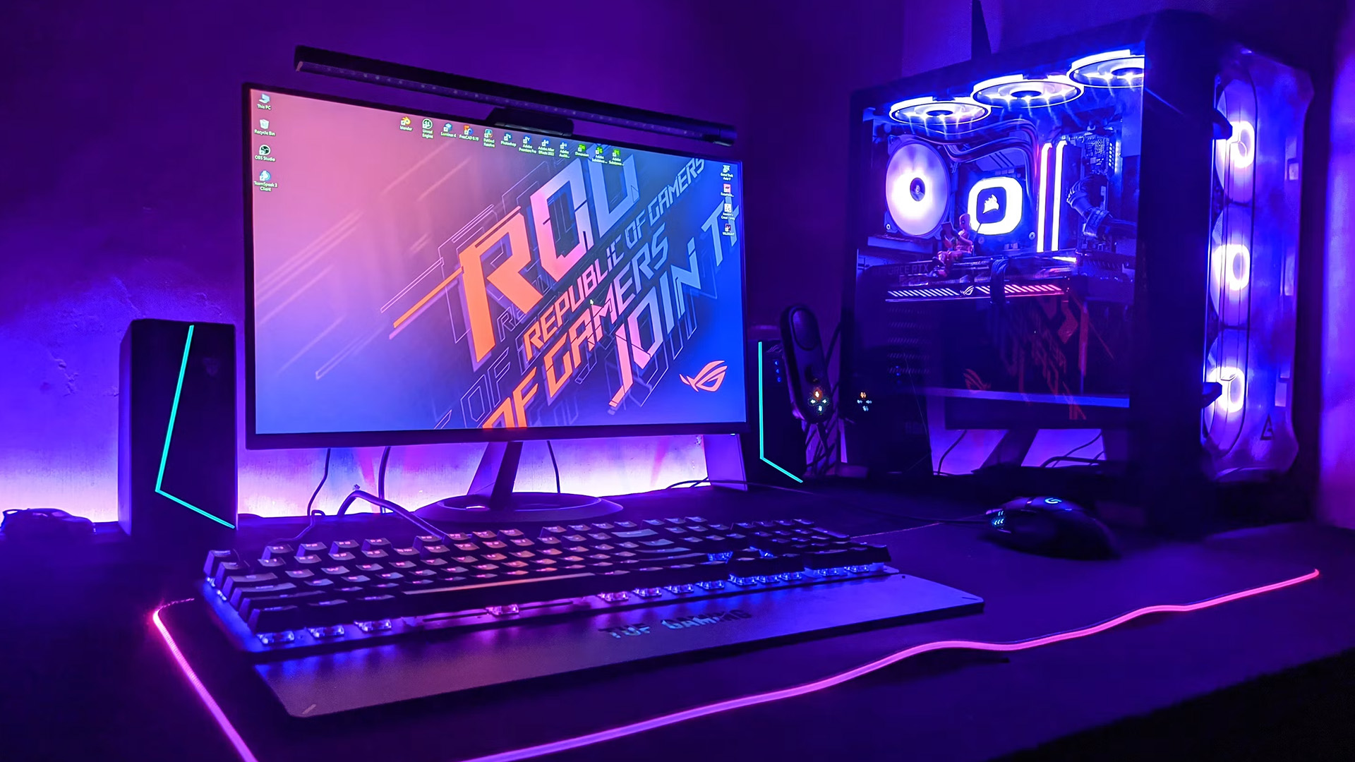A traditional gaming desktop PC tower featuring RGB lighting next to a monitor.