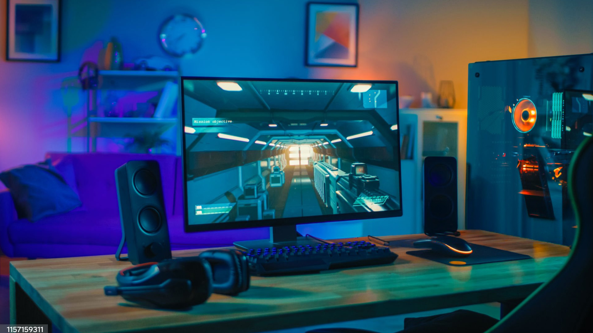 Gamer playing on a 27-inch gaming monitor in a room with blue and purple lighting.