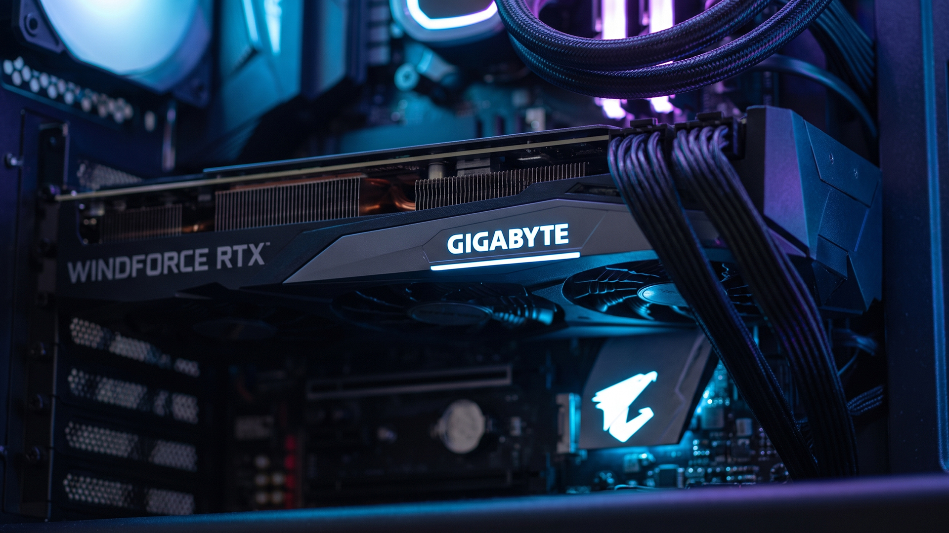 Gigabyte WINDFORCE RTX graphics card installed inside a PC case with RGB lighting.