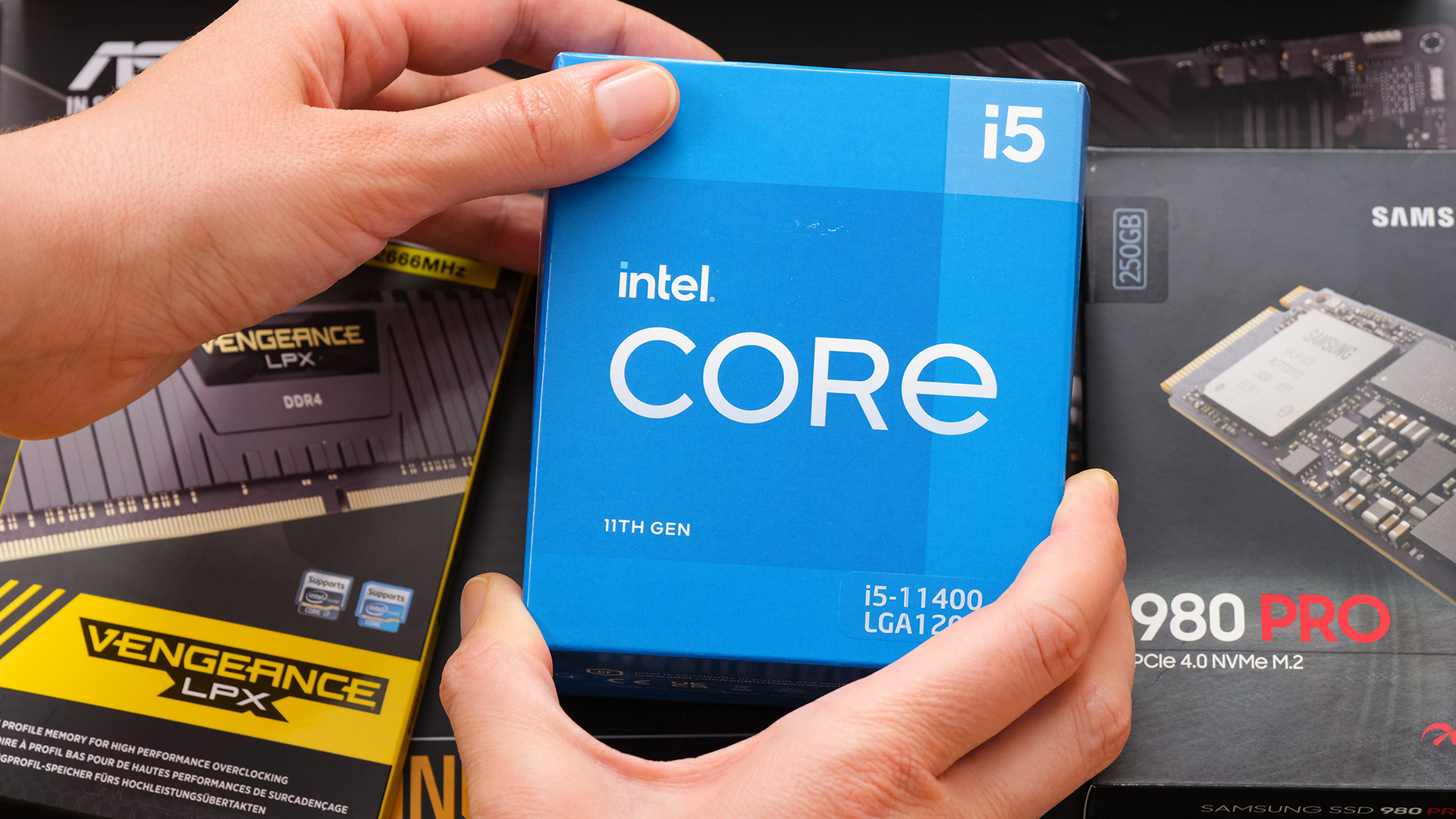 A person holding an Intel Core boxed processor retail package.