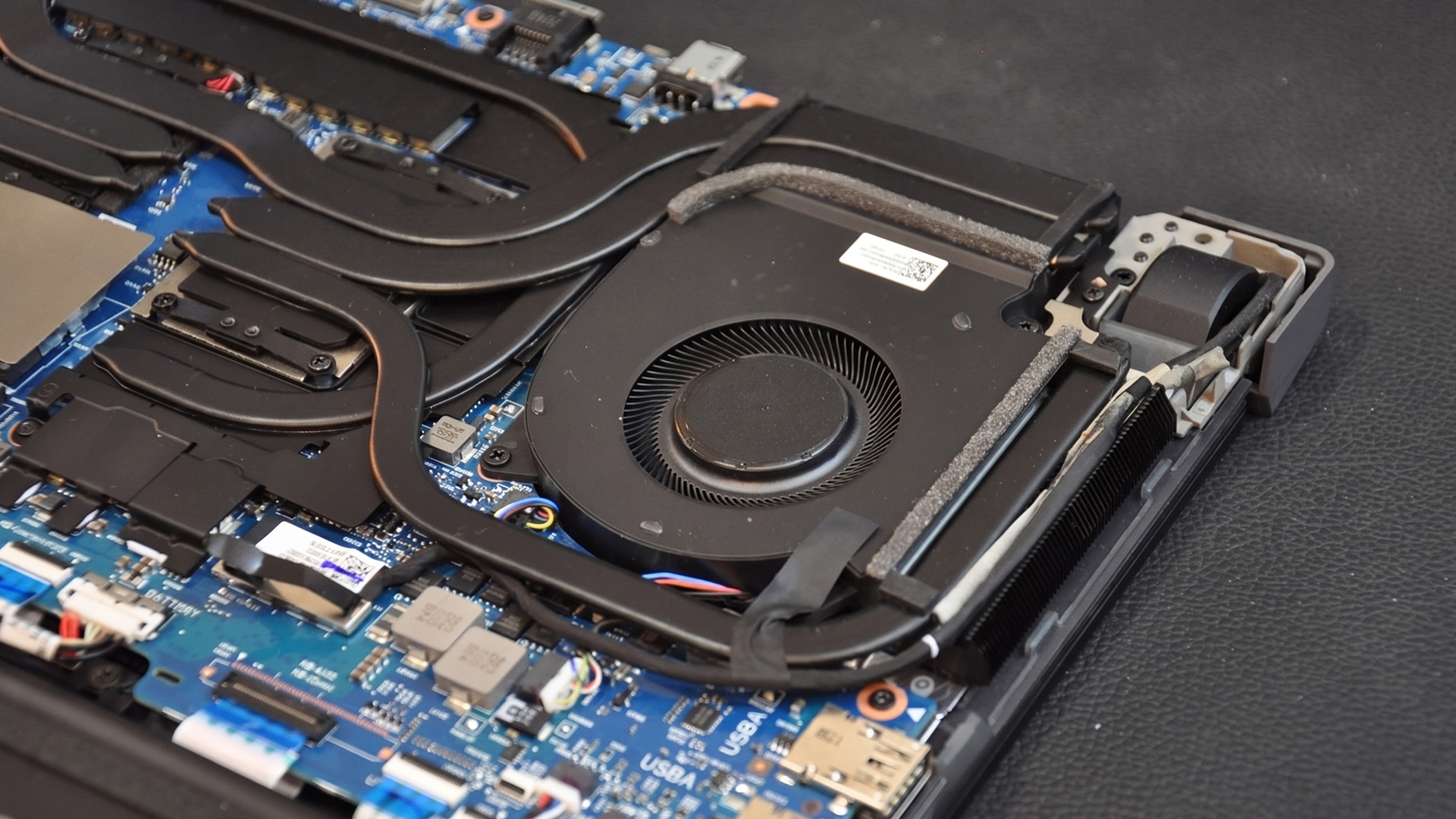Internal view of an HP OMEN gaming laptop showing the cooling fan and heat pipes.