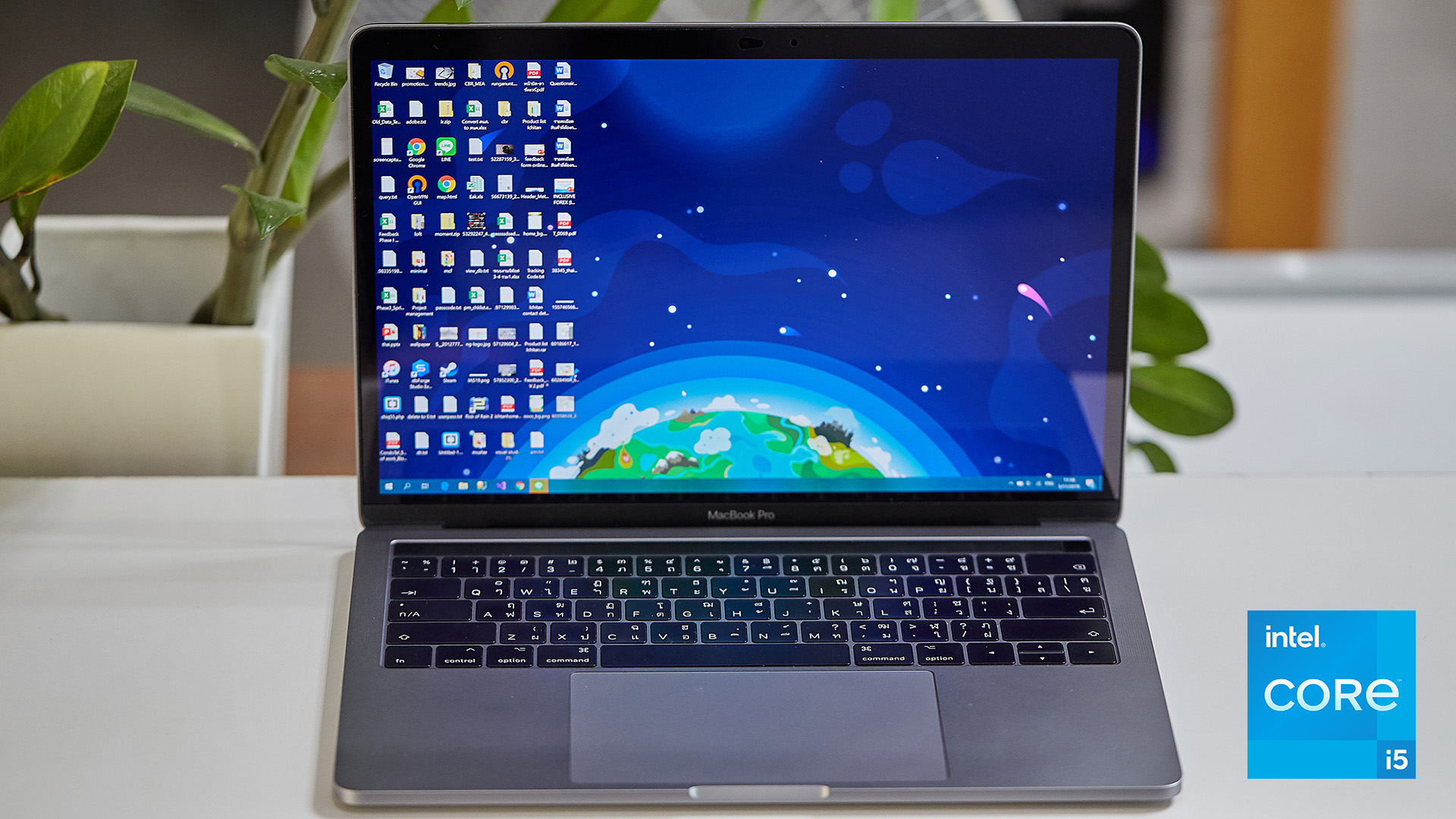 Laptop with a cluttered desktop screen and an Intel Core i5 processor badge.