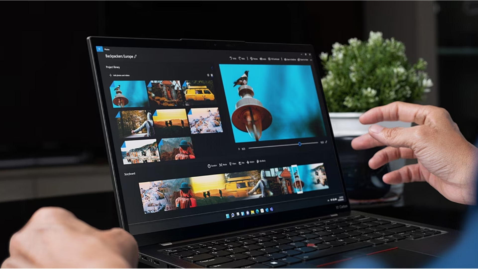 Person editing photos on a sleek Lenovo ThinkPad X1 Carbon laptop.