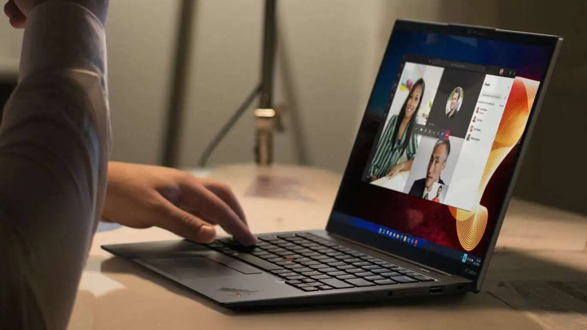 Person using a Lenovo ThinkPad X13 Gen 7 for a video call at a desk.