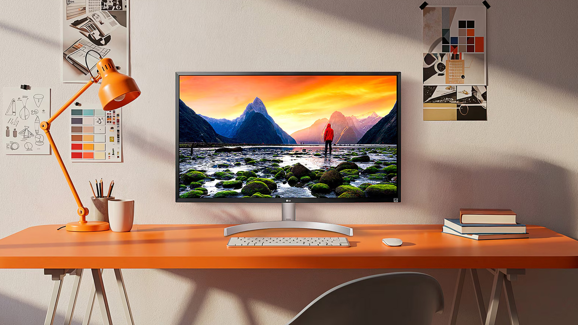 LG monitor on an office desk showing a mountain landscape.