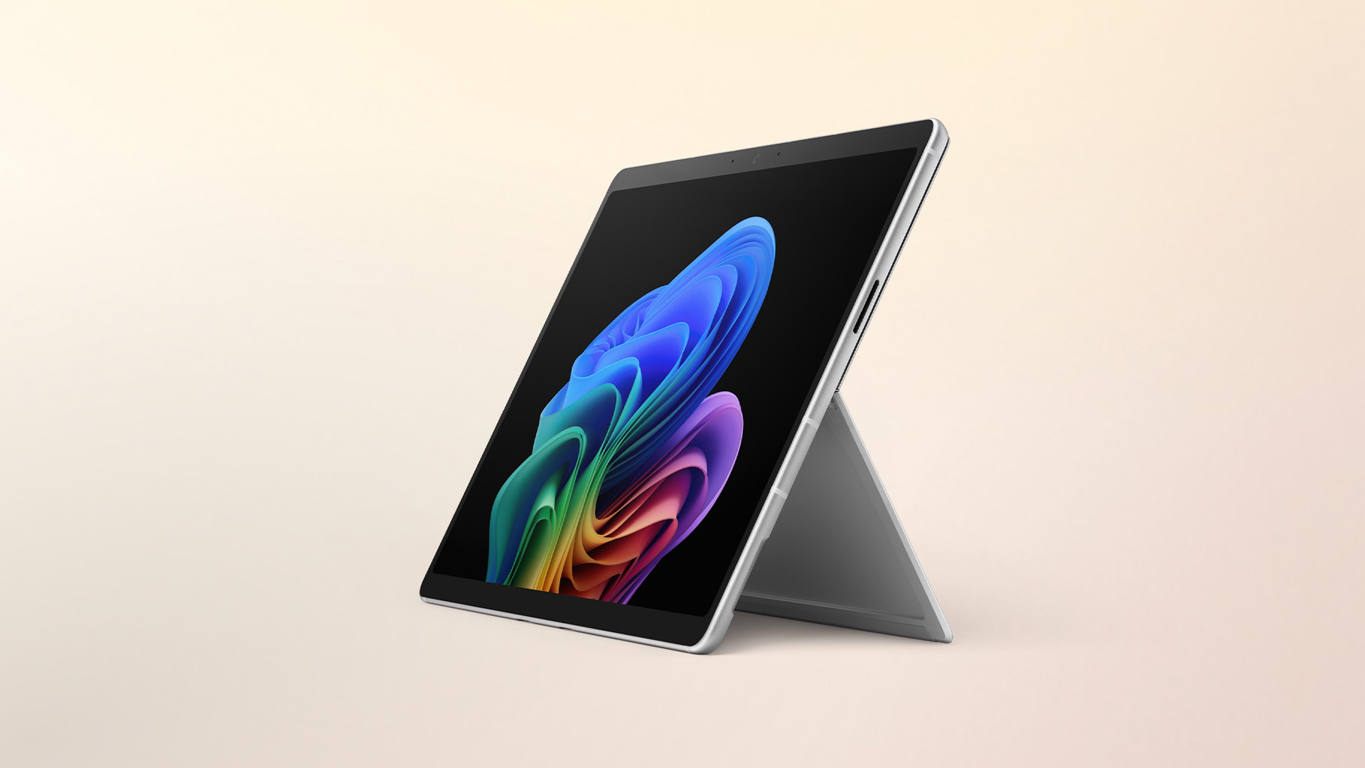 A Microsoft Surface Pro tablet resting on its kickstand displaying a colorful abstract wallpaper.