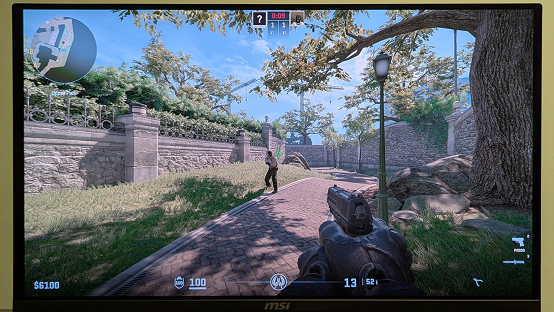 First-person shooter game displayed on an MSI gaming monitor in FPS mode.