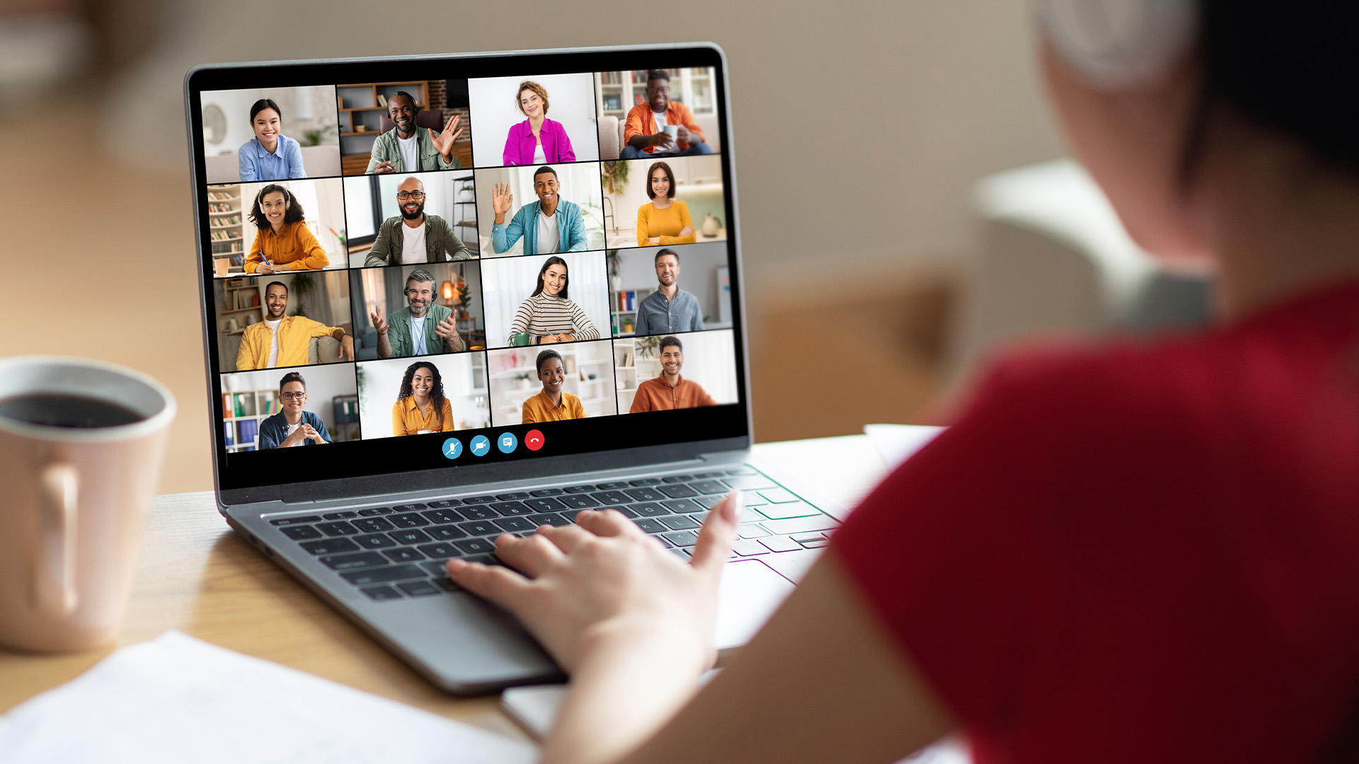 A person participating in a group video conference call on a laptop screen.