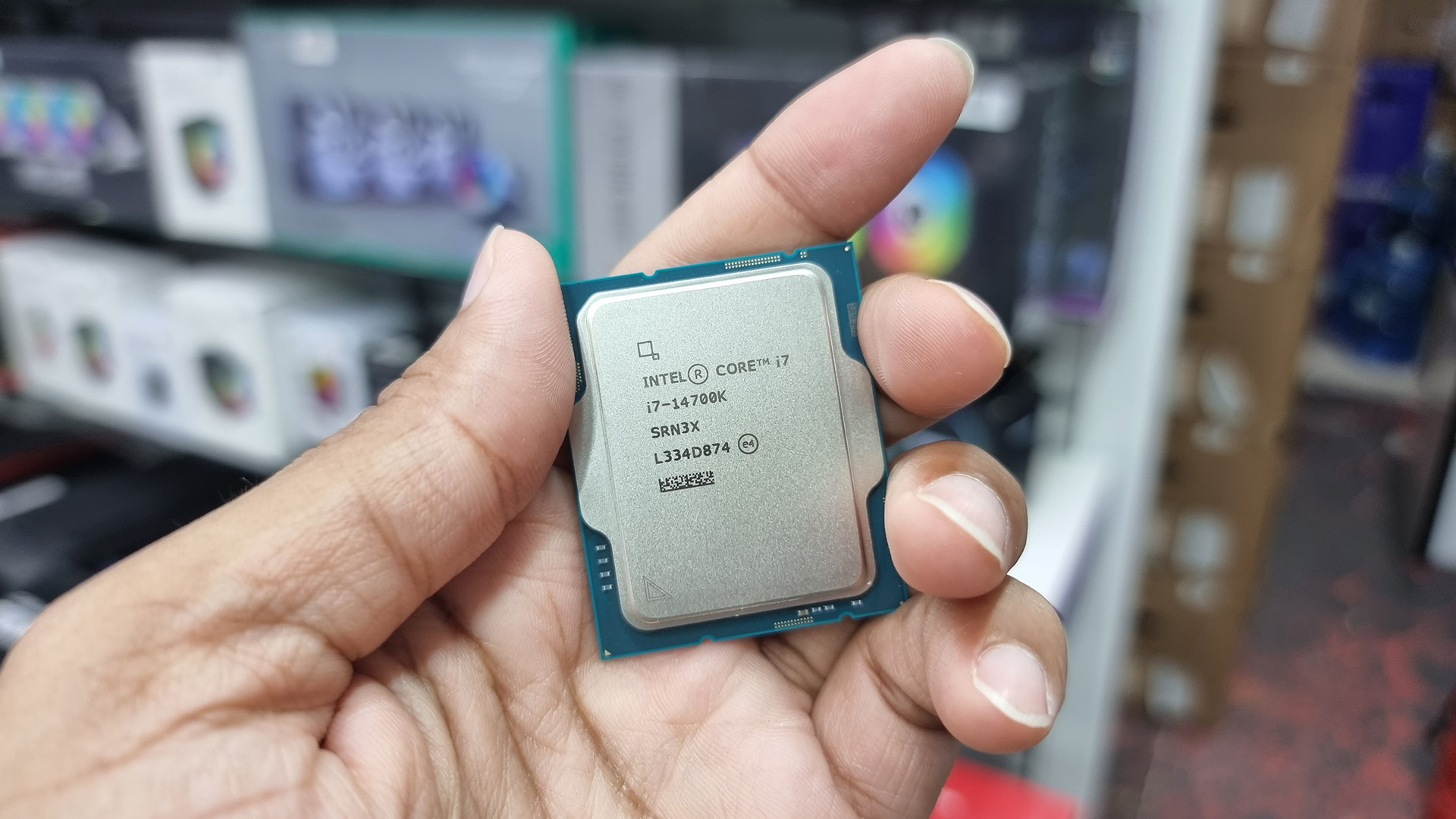 A close-up of a person holding an Intel Core CPU chip.