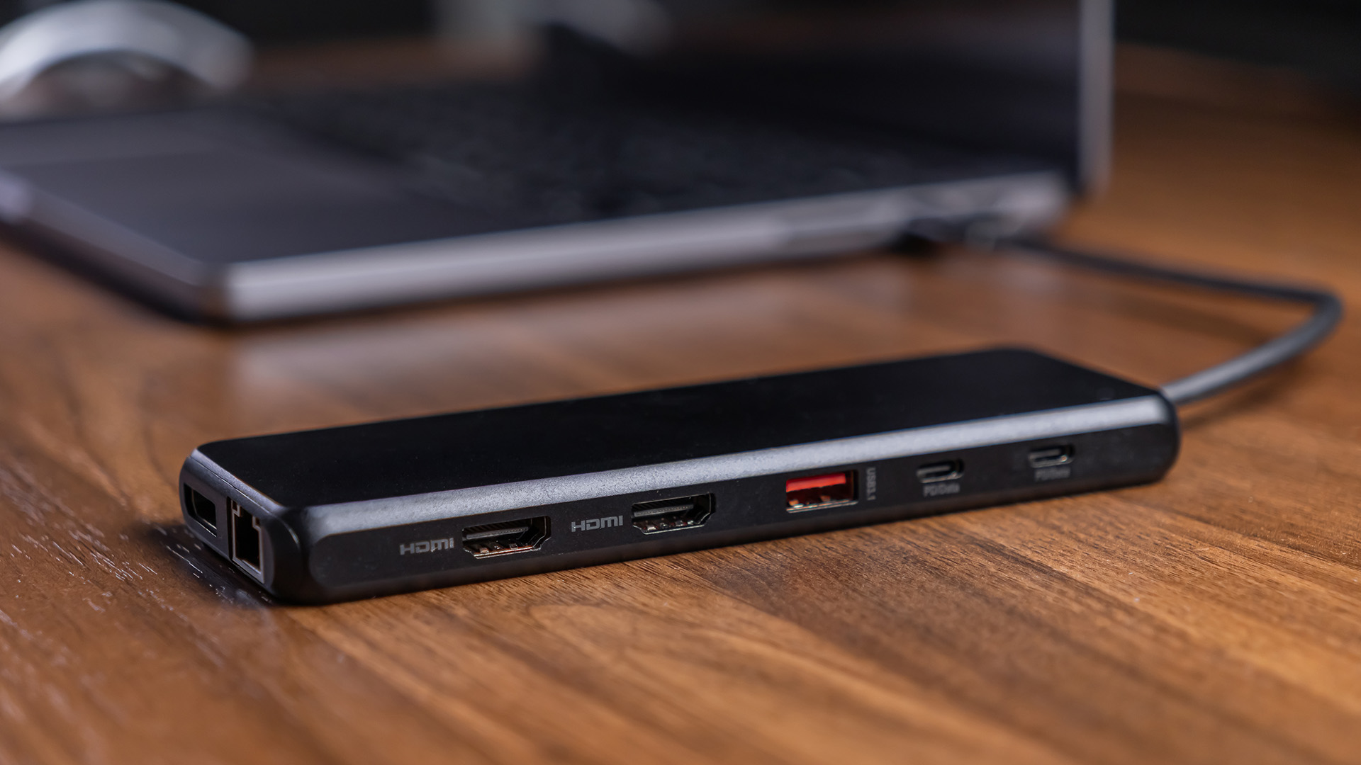 Slim laptop dock with HDMI ports connected to a laptop.