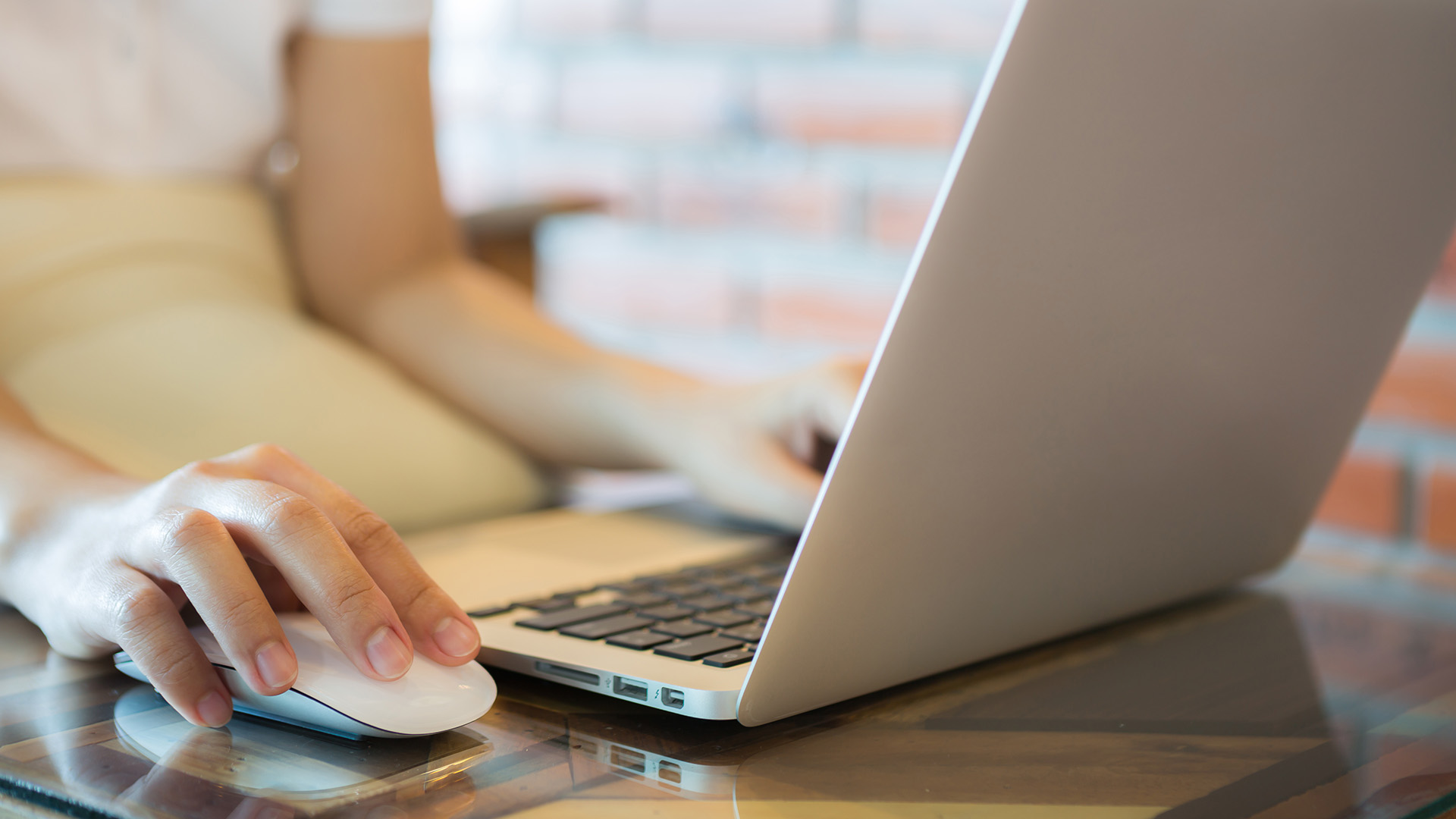 User working with a laptop and an external mouse.