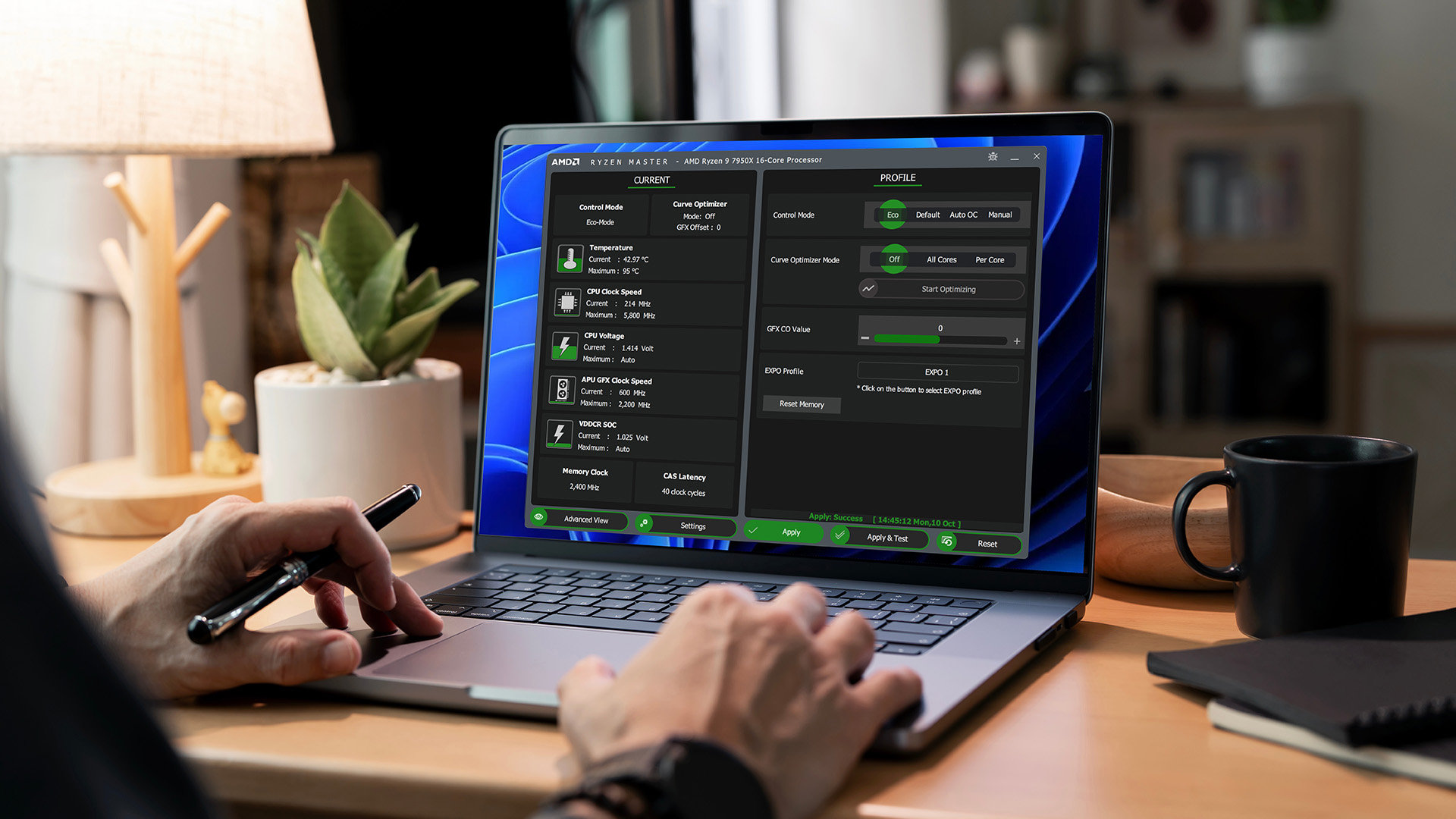 A user configuring settings on the AMD Ryzen Master software interface using a laptop.
