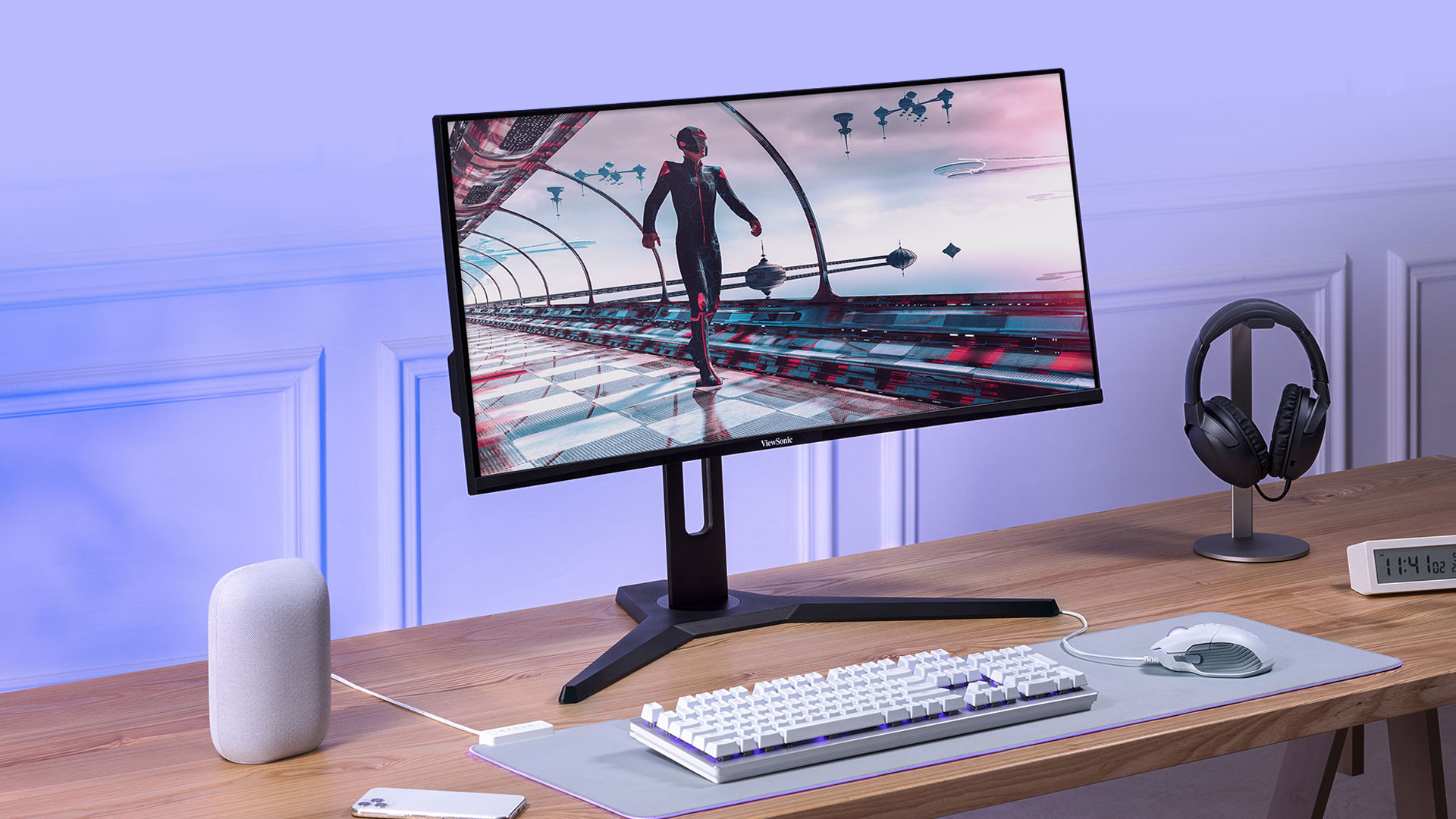 A ViewSonic monitor set up on a wooden desk with a white keyboard and mouse.