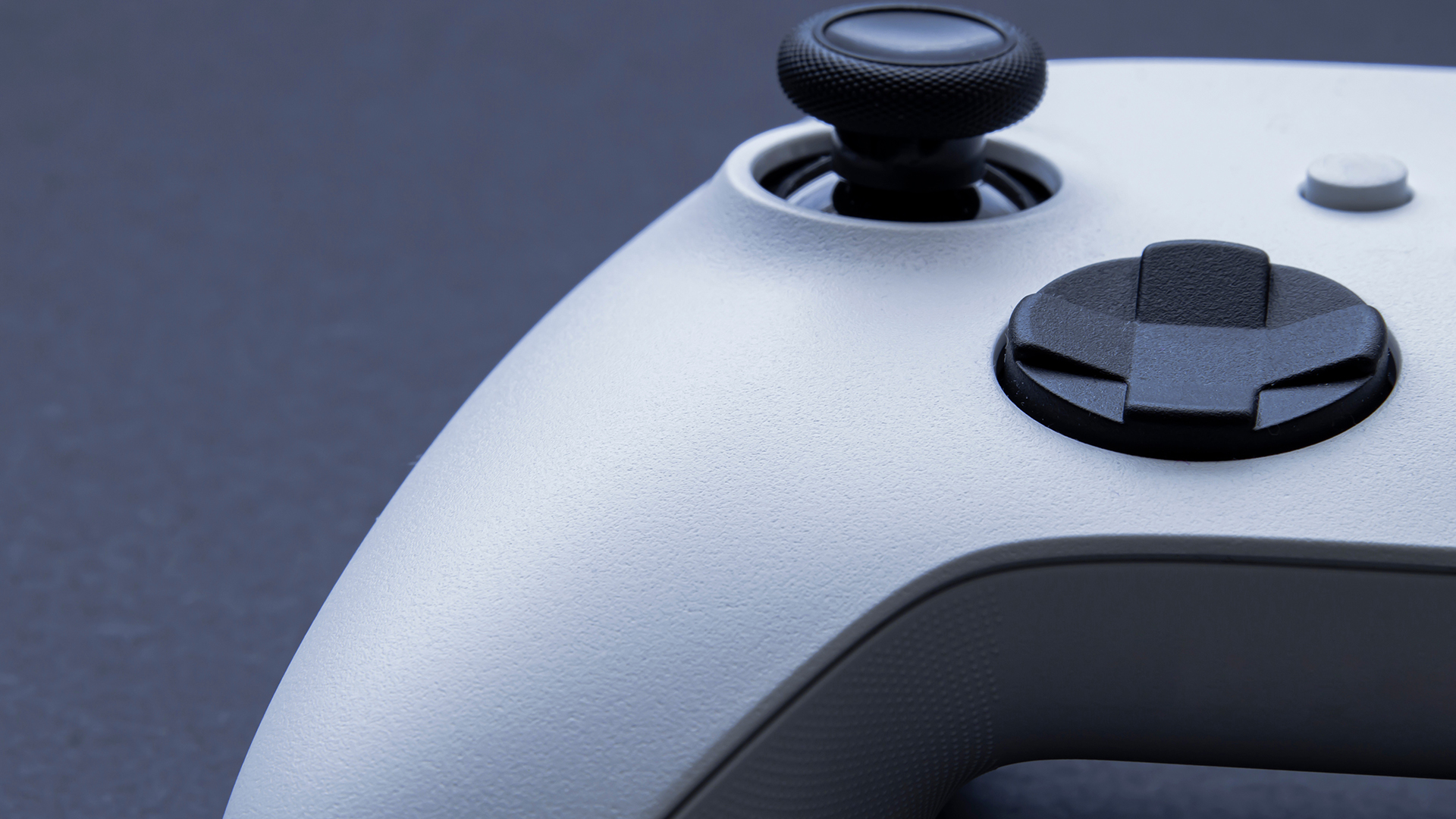 Close-up of the analogue stick on a white Xbox wireless controller.