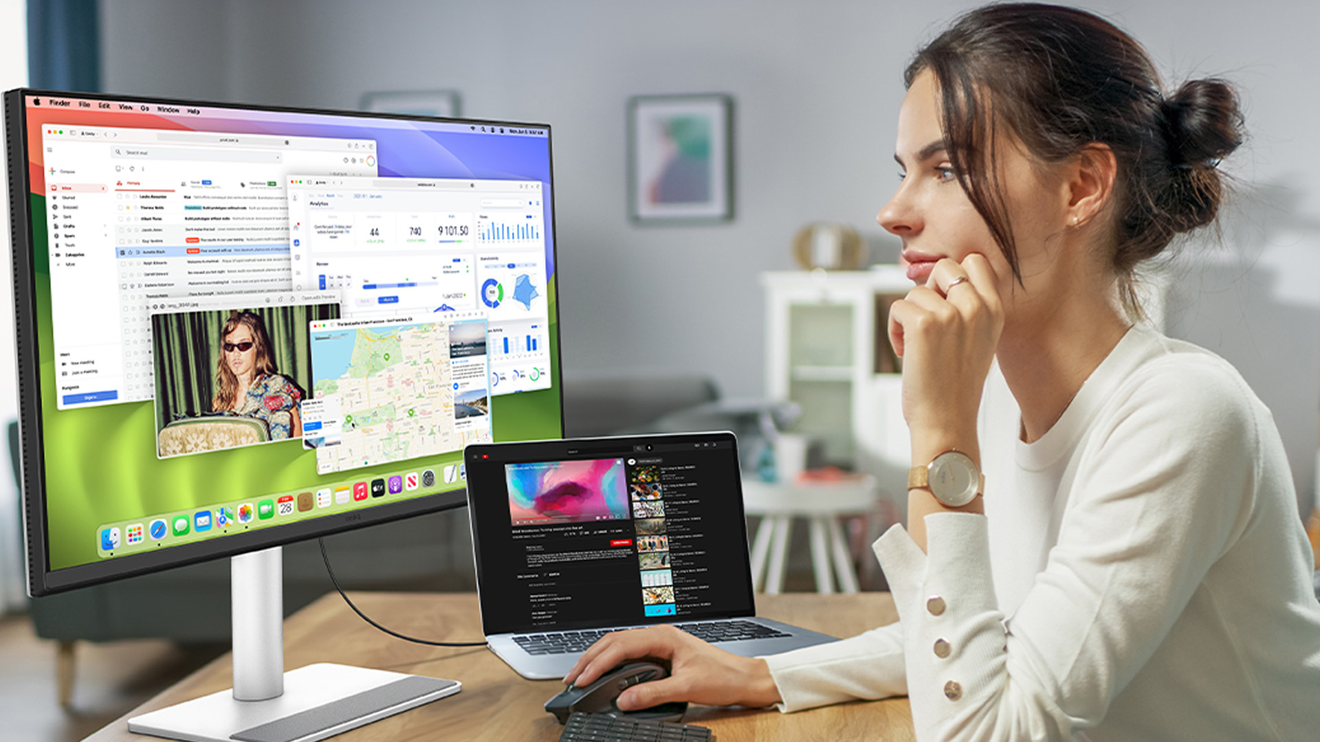 Woman multitasking with macOS app windows on a BenQ monitor and MacBook.