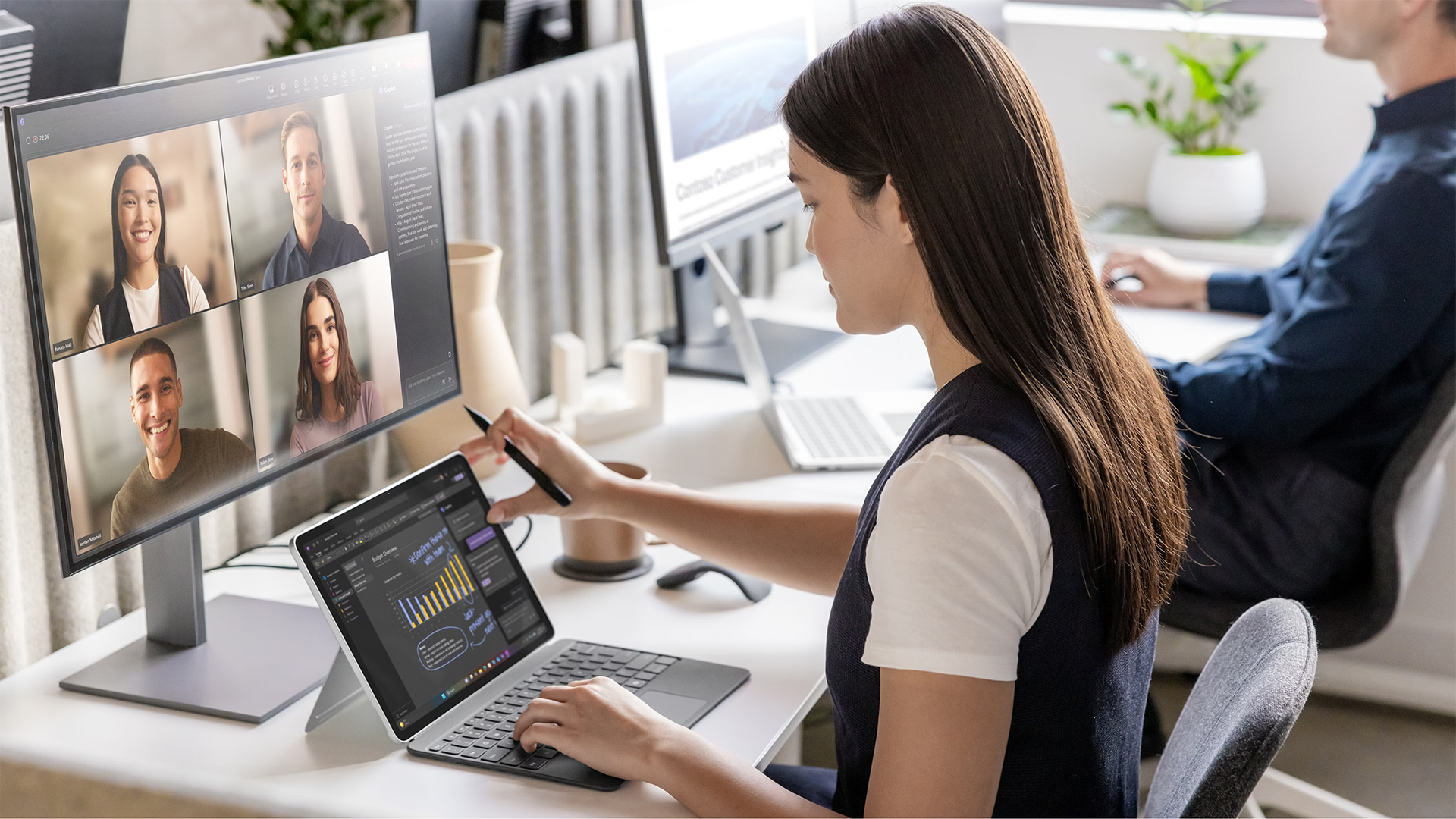 A woman using a digital pen on a Surface Pro during a video call.
